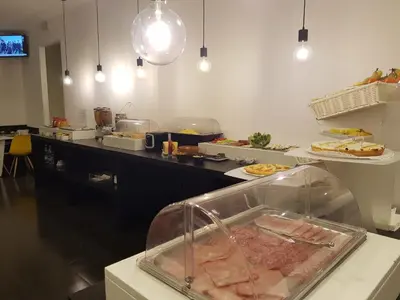 a kitchen with a counter with some food on it at Adrianus Hotel in Rome