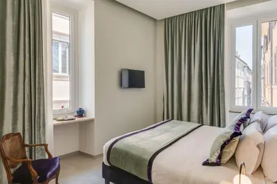 a hotel room with a bed and a window at Adrianus Hotel in Rome
