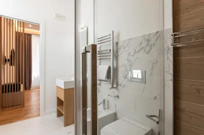 a bathroom with a sink and a toilet and a mirror at Concept Terrace Hotel in Rome