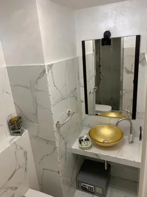 a bathroom with a gold sink and a mirror at Popolo Relax in Rome