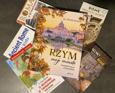 a pile of books sitting on a table at Appartamento in via Licia in Rome