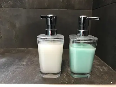 two bottles of milk and a glass of milk at Appartamento in via Licia in Rome