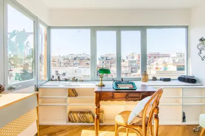 an office with a desk in front of windows at Rome Top floor with Terrace in Rome