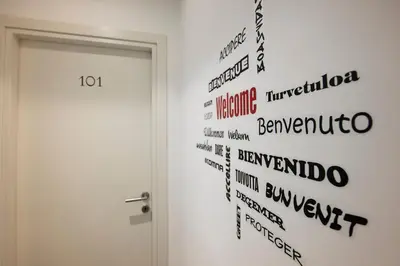 a wall with words painted on it next to a door at Inn Urbe Colosseo in Rome