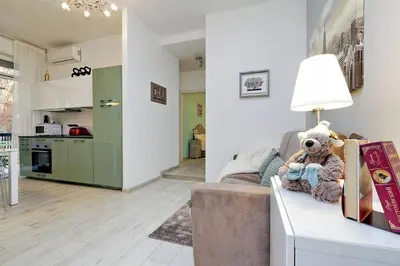 a living room with a couch and a table with a stuffed animal at Vaticano terrace: brand new 2 bedrooms 2 bathrooms in Rome