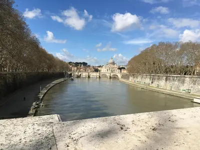 a bridge over a river with a building in the background at GARBATELLA'S in ROME in Rome