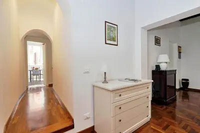 a room with a dresser with a lamp on it at Pellegrino in Rome