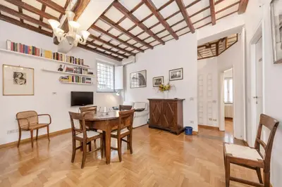 a living room with a wooden table and chairs at Campo de' Fiori Apartment in Rome