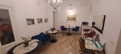 a room with two tables and chairs and a chandelier at Casa Linnea in Rome