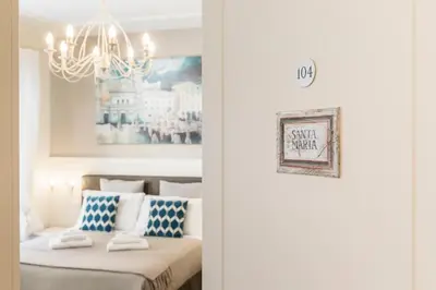 a room with a bed and a chandelier at Trastevere Gallery Suites in Rome