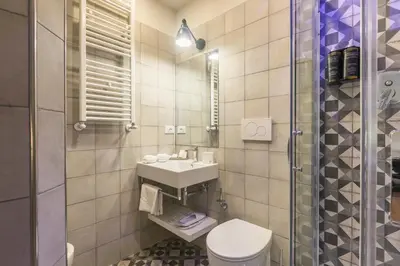 a bathroom with a toilet and a sink and a shower at Trastevere Gallery Suites in Rome