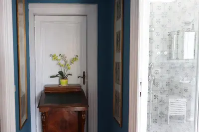 a hallway with a door with a vase on a table at Trevi Grand Blu Suite B&B in Rome