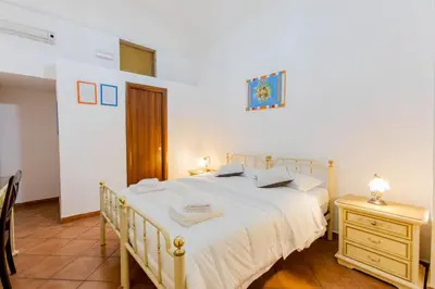 a bedroom with a large white bed and a night stand at Oscar 3 in Rome