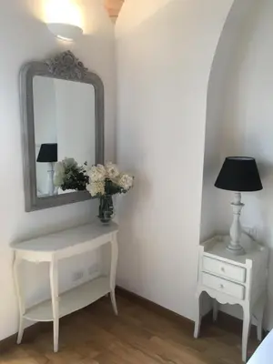 a dressing table with a mirror and a lamp at La finestra sul Colosseo B&B 1 in Rome