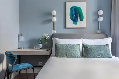 a bedroom with a large white bed with white pillows at Numa Rome Linea in Rome