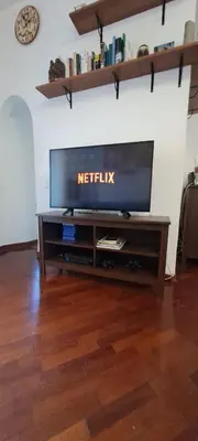 a flat screen tv sitting on top of a entertainment center at Saint Peter s roof in Rome