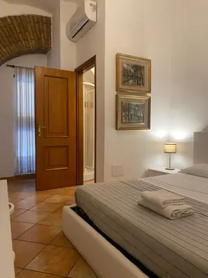 a bedroom with a bed and a door with a window at mini Apartment in Rome