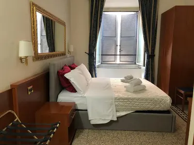 a hotel room with a bed with towels on it at mini Apartment in Rome