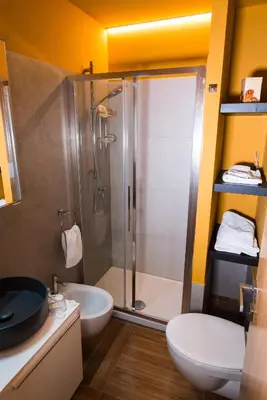 a bathroom with a shower and a toilet and a sink at Angelina Apartment Roma Monteverde in Rome