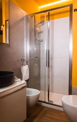 a bathroom with a shower with a toilet and a sink at Angelina Apartment Roma Monteverde in Rome