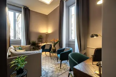 a living room with a couch and chairs at Tree Charme Parliament Boutique Hotel in Rome