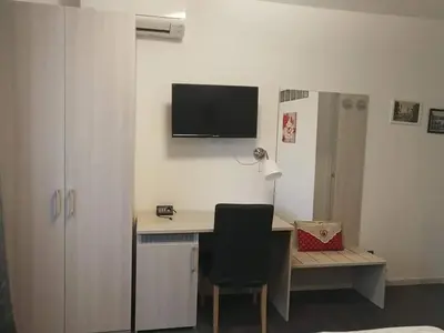 a room with a desk with a monitor on the wall at Da Angelica in Rome