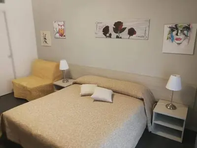a small bedroom with a bed and a chair at Da Angelica in Rome