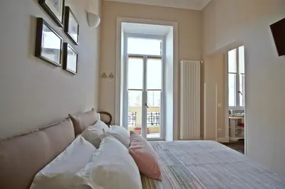 a bedroom with a bed with pillows on it at Beautiful suite in the heart of Trastevere in Rome