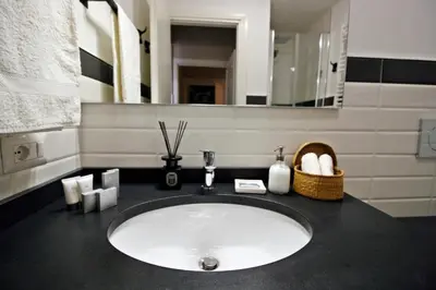 a bedroom with a bed with a pink and white blanket at Beautiful suite in the heart of Trastevere in Rome