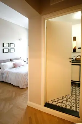 an open door leading to a bedroom with a bed at Beautiful suite in the heart of Trastevere in Rome
