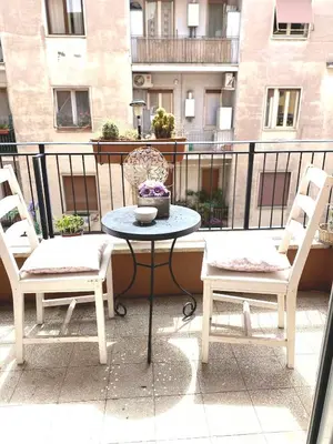 a table and two chairs on a balcony at Bed and Breakfast Zoe holiday in Rome
