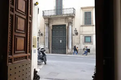 a group of people walking down a street in front of a door at Trevi Suite B&B in Rome