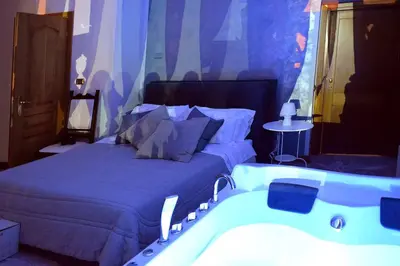 a bedroom with a bed and a bath tub at jacuzzi in front of the colosseum in Rome