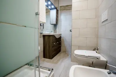 a bathroom with a toilet and a sink at Noemi's Rooms Guest House in Rome