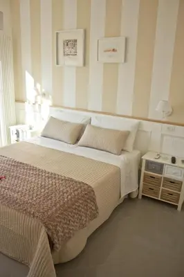 a bedroom with a large bed and a table at Glamroom Vatican Apartment in Rome