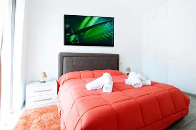 a red bed with white pillows on it in a room at New Tiburtina in Rome