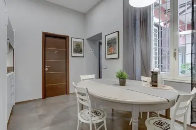 a dining room with a white table and chairs at CAPO D'AFRICA 30 - COLOSSEO in Rome
