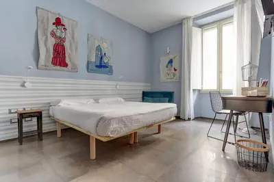 a bedroom with a bed and a table and a piano at CAPO D'AFRICA 30 - COLOSSEO in Rome