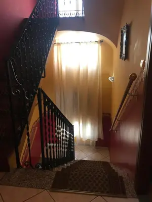 a stairway with a black railing and a window at La Casa di Elena in Rome