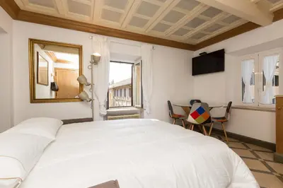 a bedroom with a large white bed and a window at Giuditta Suite 121 Trastevere Roma in Rome