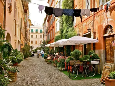 a street with a market with a bicycle and umbrellas at Boutique Apartment Roma in Trastevere in Rome