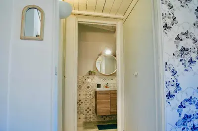 a bathroom with a mirror and a sink at Boutique Apartment Roma in Trastevere in Rome