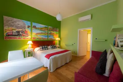 a green room with a bed and a couch at Casa Martini in Rome