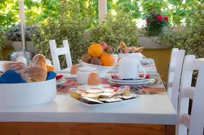 a table with a breakfast of eggs bread and fruit at Casa Martini in Rome