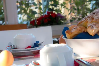a table with a bowl of bread and a cup of coffee at Casa Martini in Rome