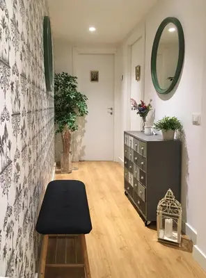 a living room with a black ottoman and a mirror at M SuiteApartment Roma in Rome