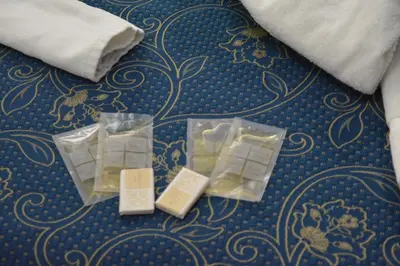 a pile of soap in plastic containers on a floor at Locanda Otello in Rome