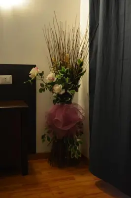 a vase filled with flowers in a room at Locanda Otello in Rome