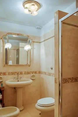 a bathroom with a sink and a toilet and a mirror at Armonia All'Opera in Rome