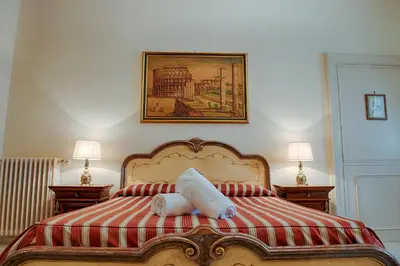 a bed with a stuffed animal laying on top of it at Armonia All'Opera in Rome
